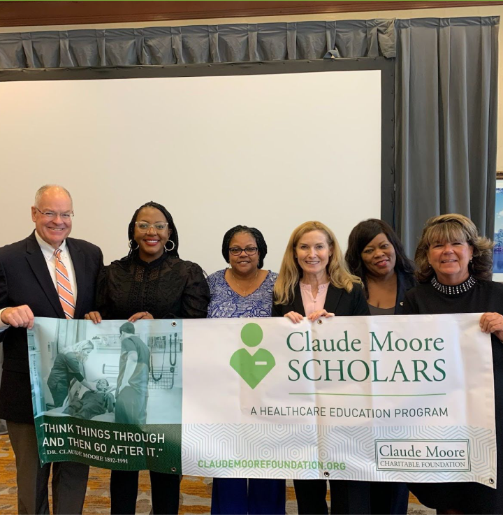 Claude Moore Scholars collaborators holding program banner